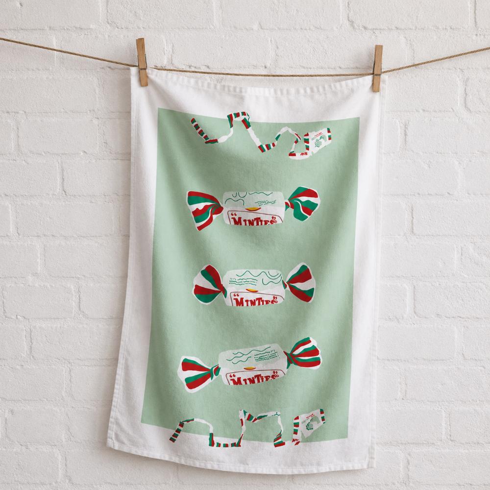Iconic Minties Tea Towel featuring Australia's famous chewy Minties wrappers and the classic wrapper-tearing game that generations of Aussies remember.
