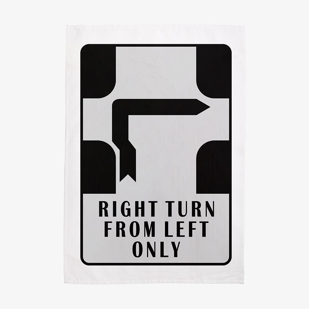 Make Me Iconic’ Melbourne Hook Turn Tea Towel featuring the iconic "Right Turn from Left Only" road sign in bold black and white. A playful nod to Melbourne’s famously confusing driving rule, printed on a cotton-linen blend towel perfect for kitchens, gifts, or nostalgic decor.