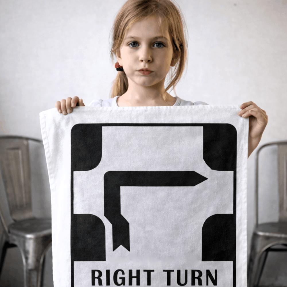 Make Me Iconic’ Melbourne Hook Turn Tea Towel featuring the iconic "Right Turn from Left Only" road sign in bold black and white. A playful nod to Melbourne’s famously confusing driving rule, printed on a cotton-linen blend towel perfect for kitchens, gifts, or nostalgic decor.