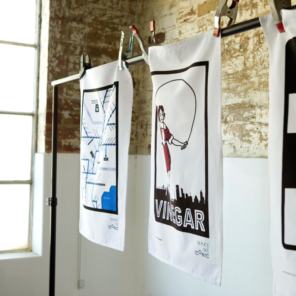 Make Me Iconic Melbourne Train Network Tea Towel featuring an illustrated map of Melbourne’s railway system, an Australian souvenir celebrating iconic public transport.
