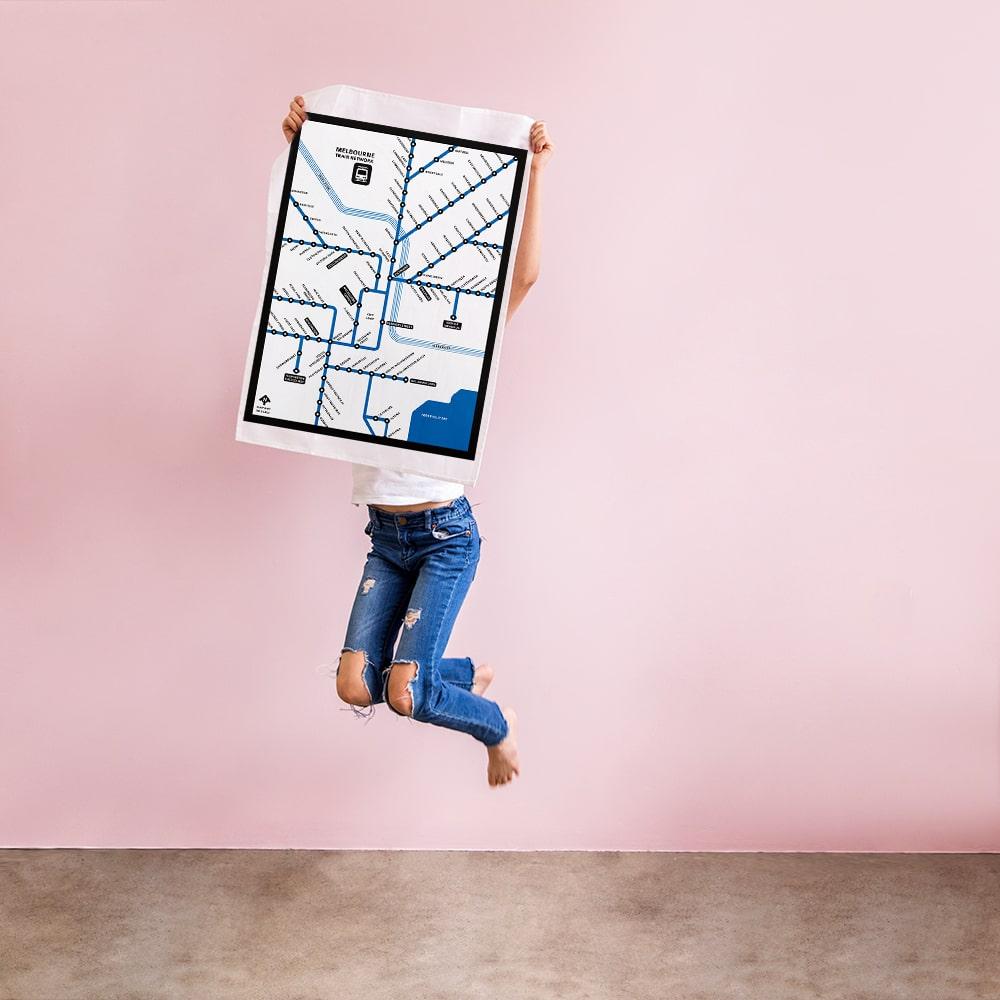 Make Me Iconic Melbourne Train Network Tea Towel featuring an illustrated map of Melbourne’s railway system, an Australian souvenir celebrating iconic public transport.