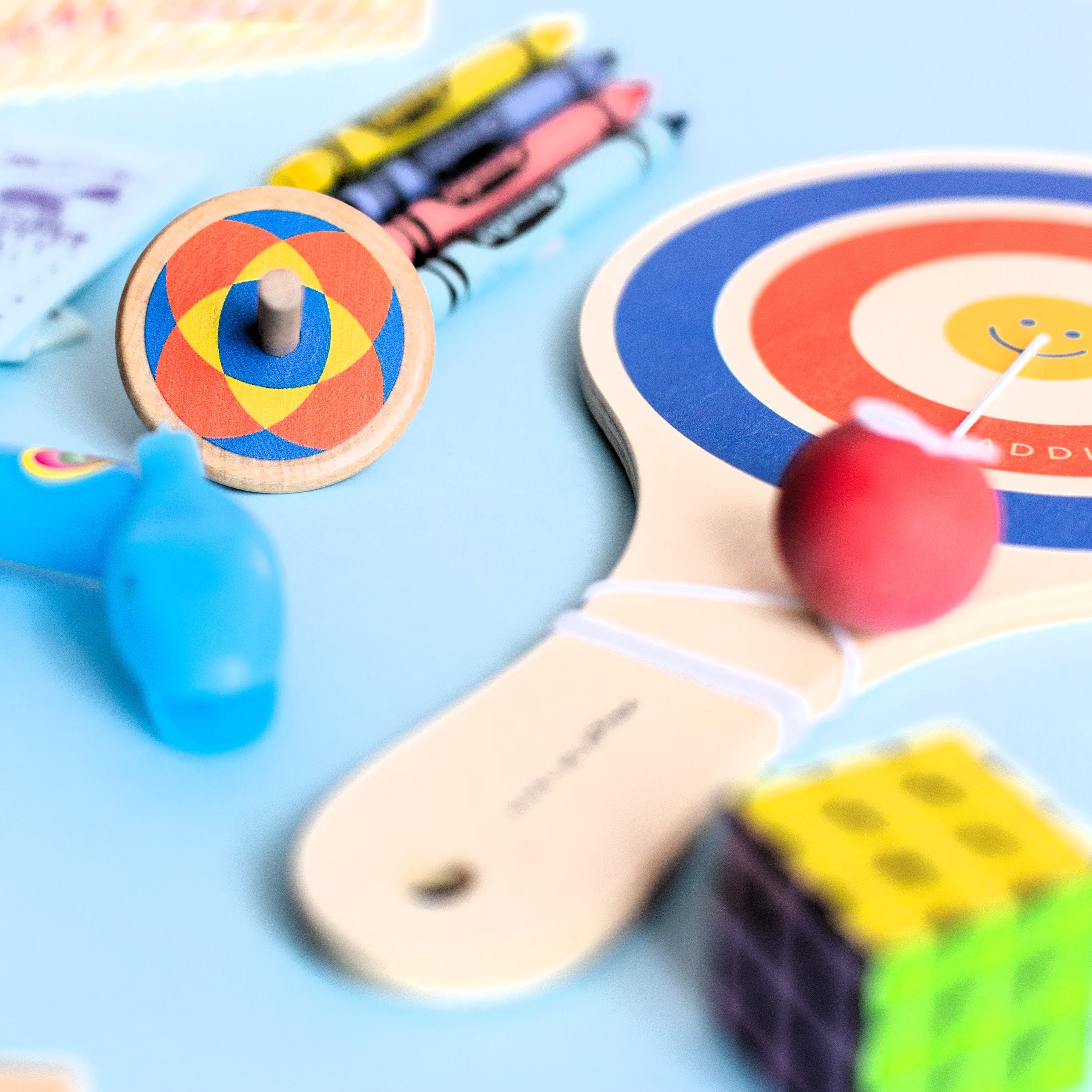 Wooden paddle ball toy with elastic rubber ball, designed for solo play and developing hand-eye coordination. A classic retro toy perfect for travel, parties, or active play at home.