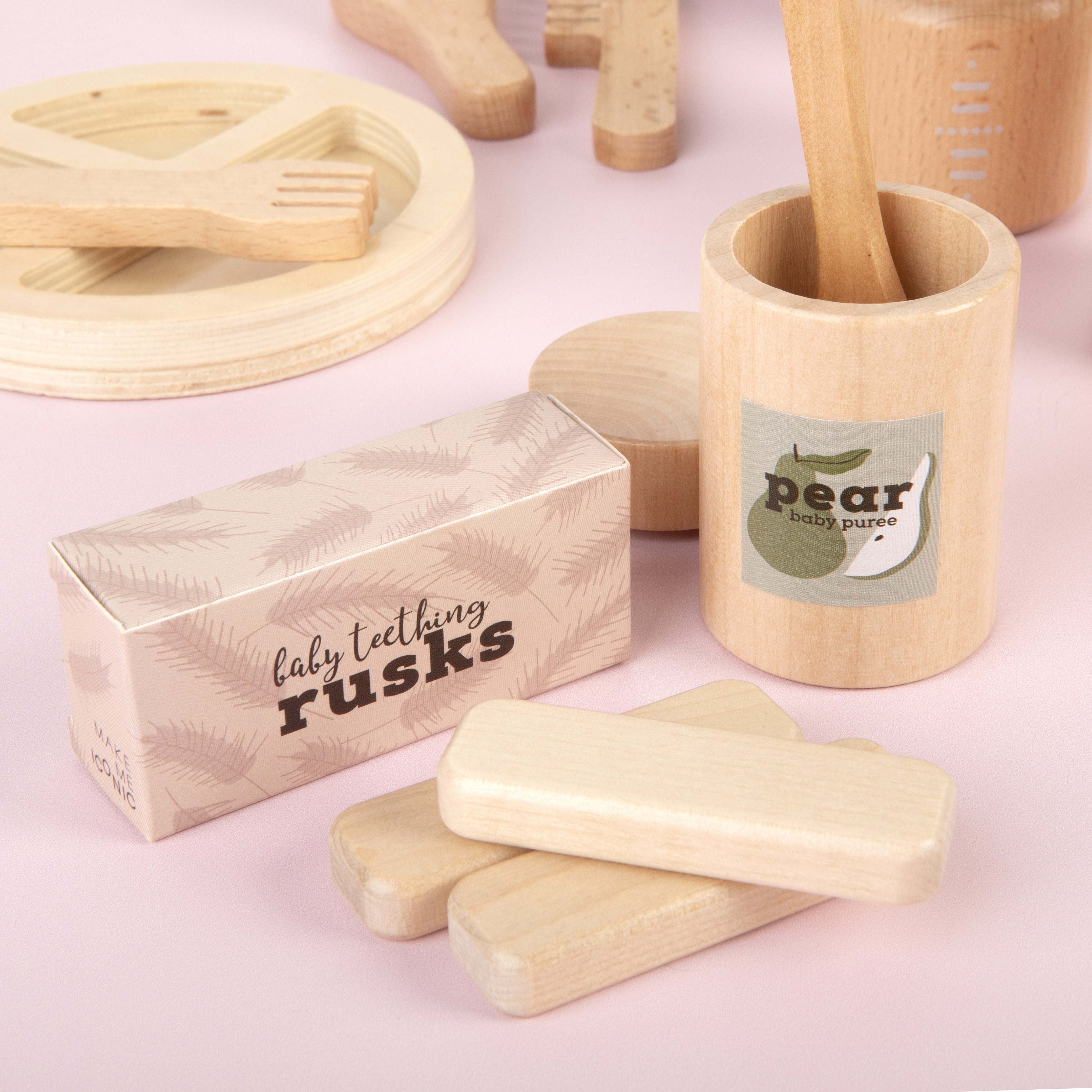 Set of 3 wooden toy doll rusks in a cardboard box, designed for pretend feeding and nurturing role-play. Perfect for developing empathy, fine motor skills, and imaginative play in young children.