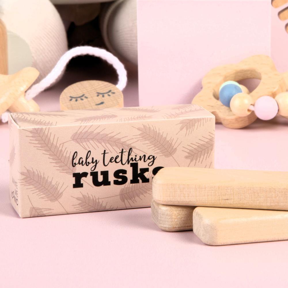Make Me Iconic set of 3 wooden toy doll rusks in a cardboard box, designed for pretend feeding and nurturing role-play. Perfect for developing empathy, fine motor skills, and imaginative play in young children.