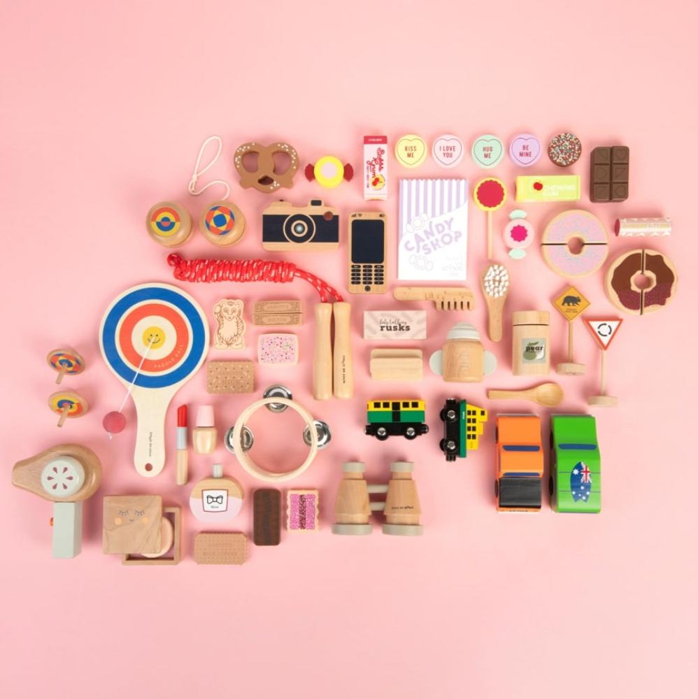 Make Me Iconic set of 3 wooden toy doll rusks in a cardboard box, designed for pretend feeding and nurturing role-play. Perfect for developing empathy, fine motor skills, and imaginative play in young children.