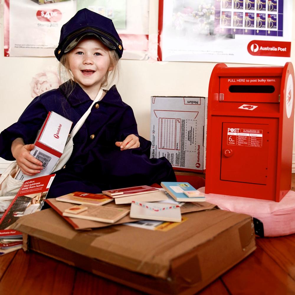 Australian Post Box wooden toy featuring a working mail slot, wooden letters, postcards and stamps. A nostalgic role-play toy inspired by the iconic red Australia Post Box.