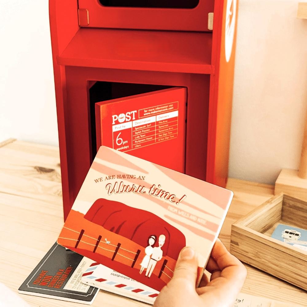 Australian Post Box wooden toy featuring a working mail slot, wooden letters, postcards and stamps. A nostalgic role-play toy inspired by the iconic red Australia Post Box.