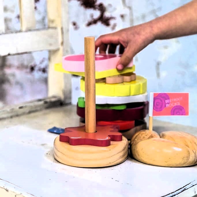 Wooden Aussie stacking burger toy for kids with colourful layers, mini flags, and chunky pieces—perfect for imaginative food play and motor skill development.