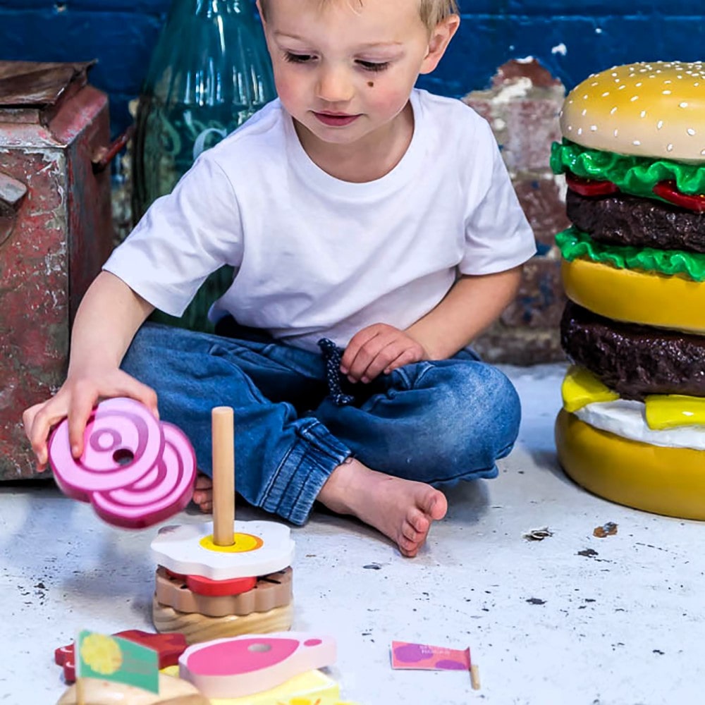 Wooden Aussie stacking burger toy for kids with colourful layers, mini flags, and chunky pieces—perfect for imaginative food play and motor skill development.