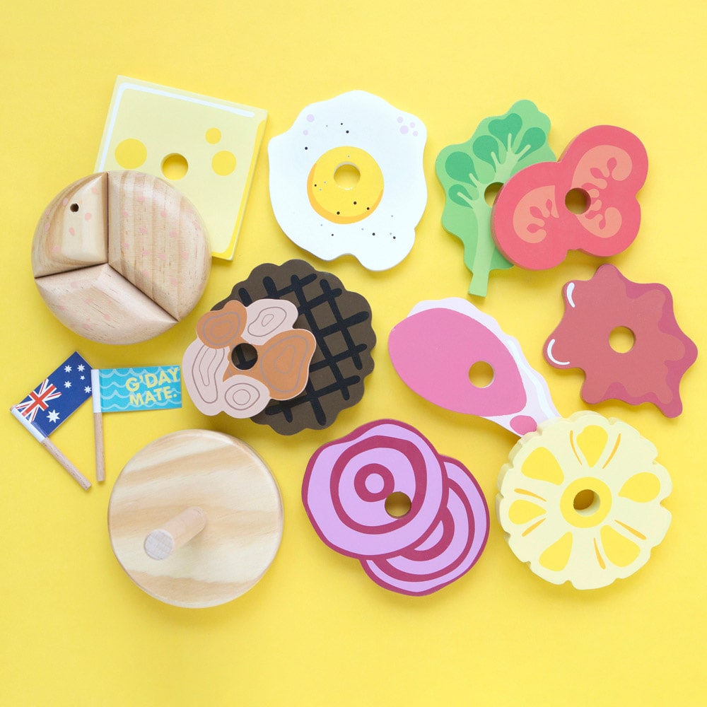 Wooden Aussie stacking burger toy for kids with colourful layers, mini flags, and chunky pieces—perfect for imaginative food play and motor skill development.