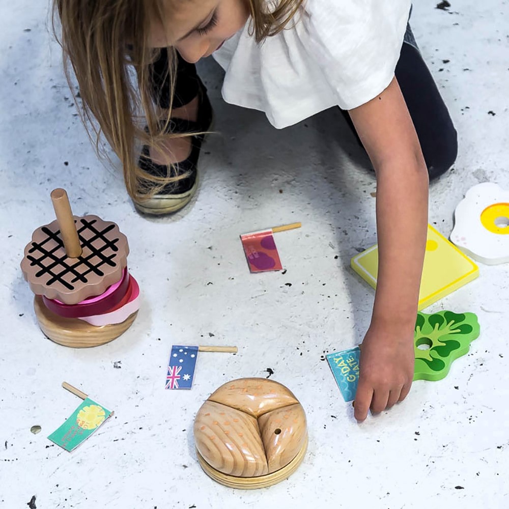 Wooden Aussie stacking burger toy for kids with colourful layers, mini flags, and chunky pieces—perfect for imaginative food play and motor skill development.