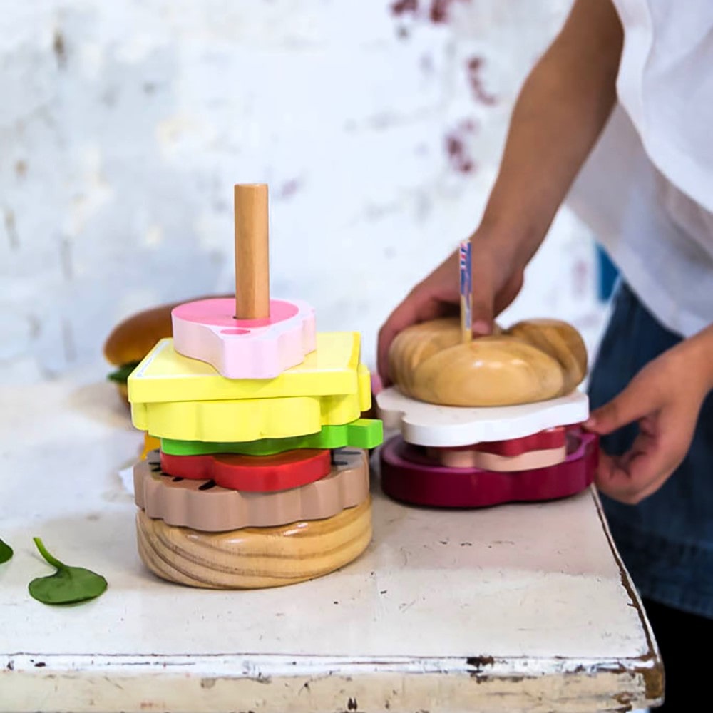 Wooden Aussie stacking burger toy for kids with colourful layers, mini flags, and chunky pieces—perfect for imaginative food play and motor skill development.