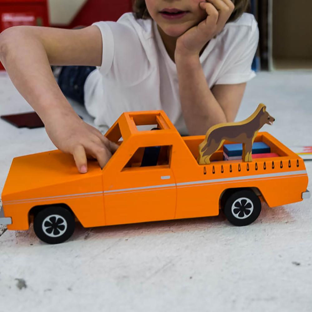 Wooden Aussie Ute toy inspired by Australia's iconic utility vehicle. Features rolling wheels, removable accessories and wooden passengers for imaginative play.