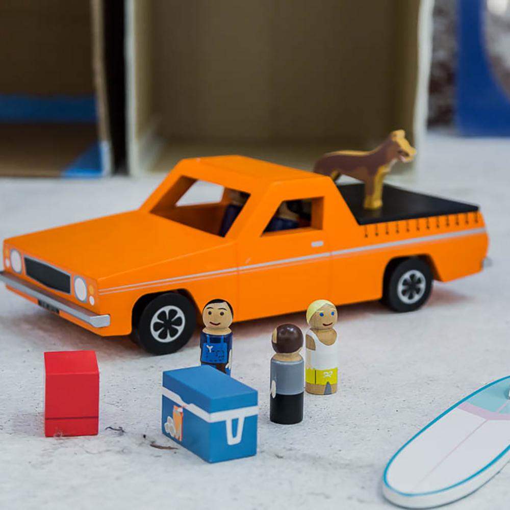 Wooden Aussie Ute toy inspired by Australia's iconic utility vehicle. Features rolling wheels, removable accessories and wooden passengers for imaginative play.