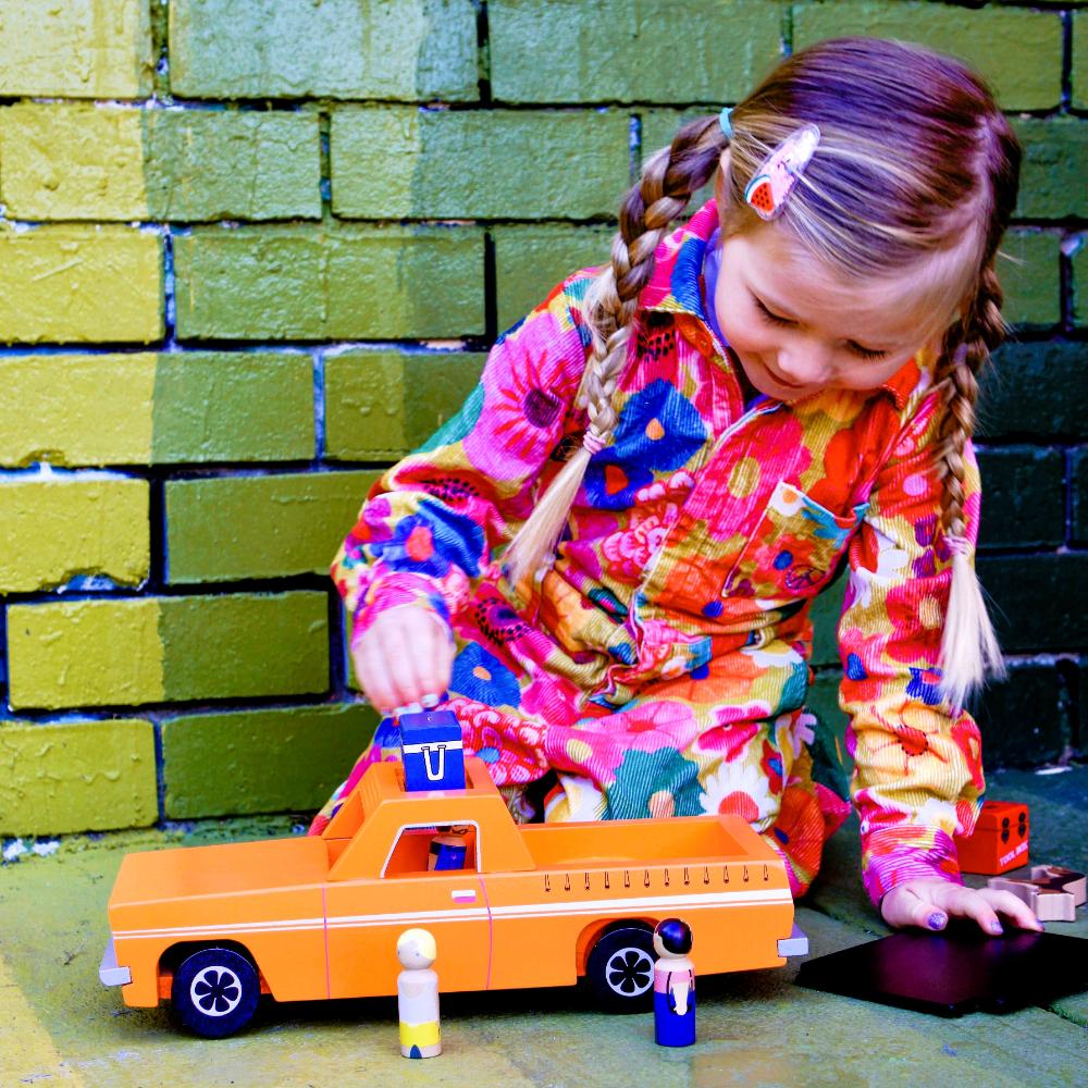 Wooden Aussie Ute toy inspired by Australia's iconic utility vehicle. Features rolling wheels, removable accessories and wooden passengers for imaginative play.