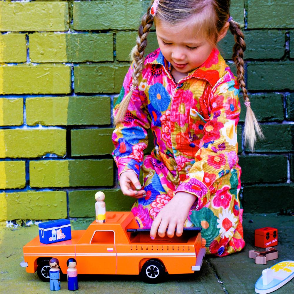 Wooden Aussie Ute toy inspired by Australia's iconic utility vehicle. Features rolling wheels, removable accessories and wooden passengers for imaginative play.
