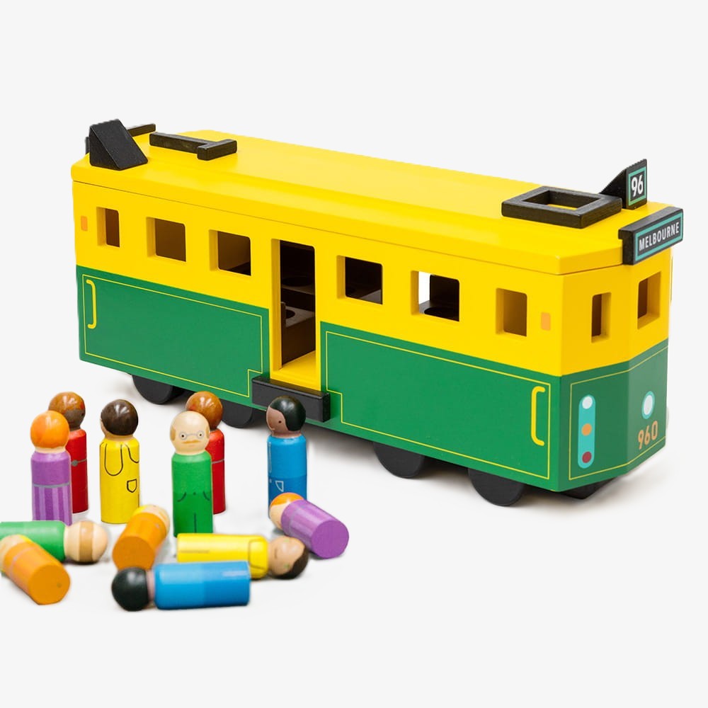 Wooden Melbourne tram toy inspired by the W-Class tram, featuring green and gold detailing, rolling wheels, removable roof, and 14 wooden passenger figures.