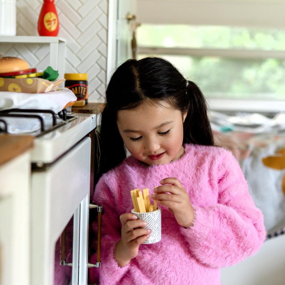Make Me Iconic Australian wooden toy food set, 38-piece pretend play set featuring Vegemite, Fairy Bread, Pavlova, Lamington, meat pie, snag in bread, and hot Chips with sauce for imaginative kitchen play.