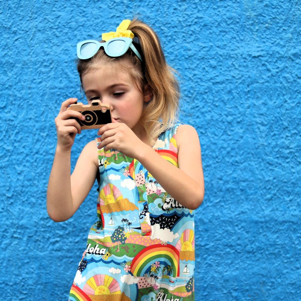 Make Me Iconic wooden toy camera for kids with a real viewfinder and a pressable button, designed for imaginative pretend play and creative role-play photography fun.