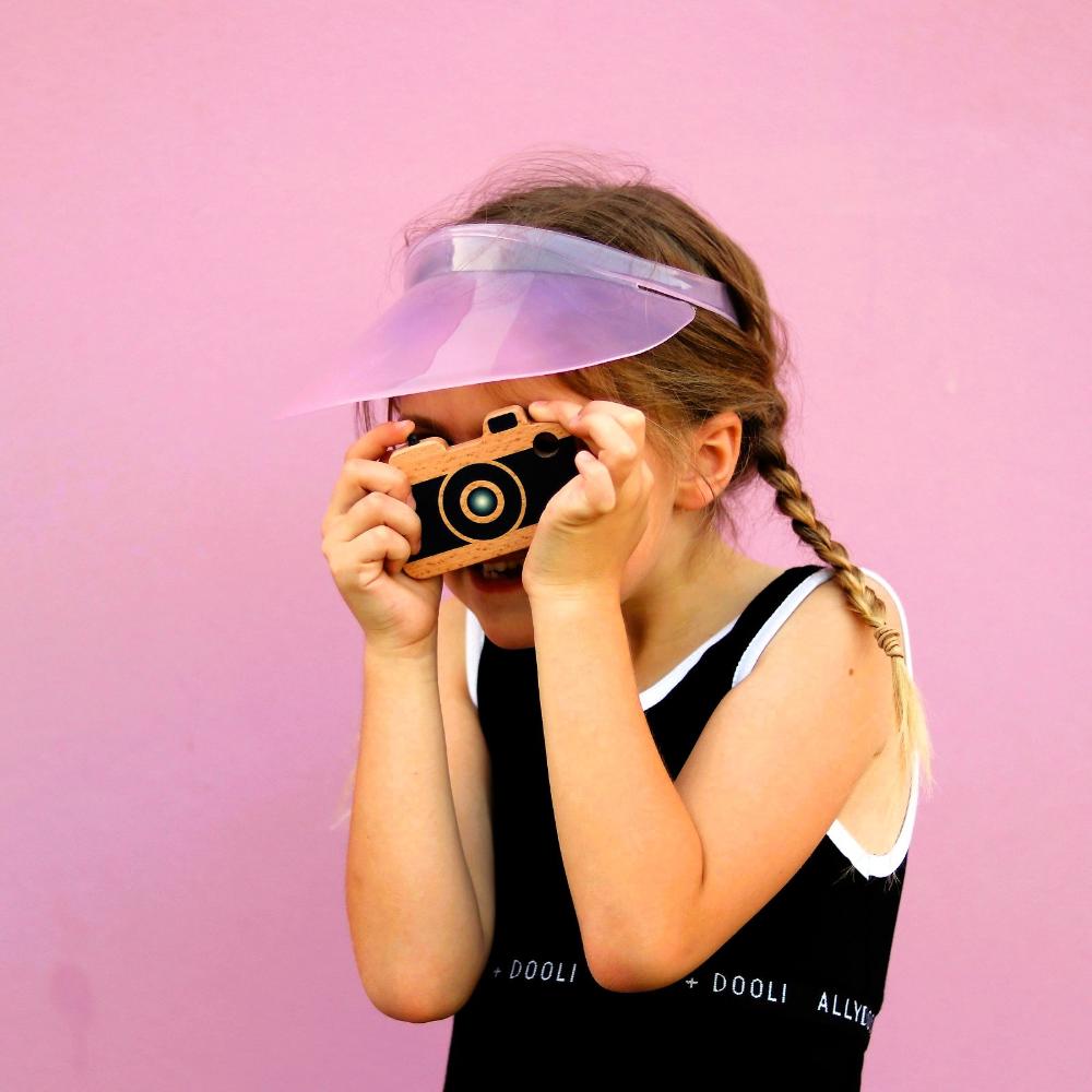 Make Me Iconic wooden toy camera for kids with a real viewfinder and a pressable button, designed for imaginative pretend play and creative role-play photography fun.