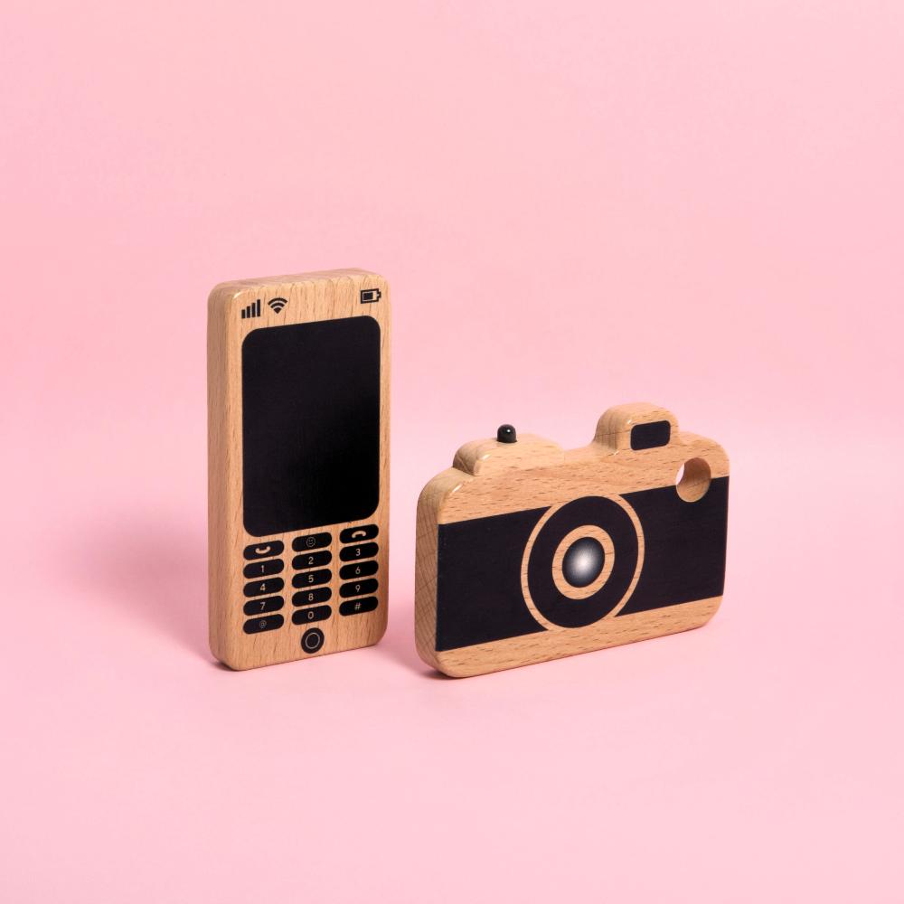 Make Me Iconic wooden toy camera for kids with a real viewfinder and a pressable button, designed for imaginative pretend play and creative role-play photography fun.