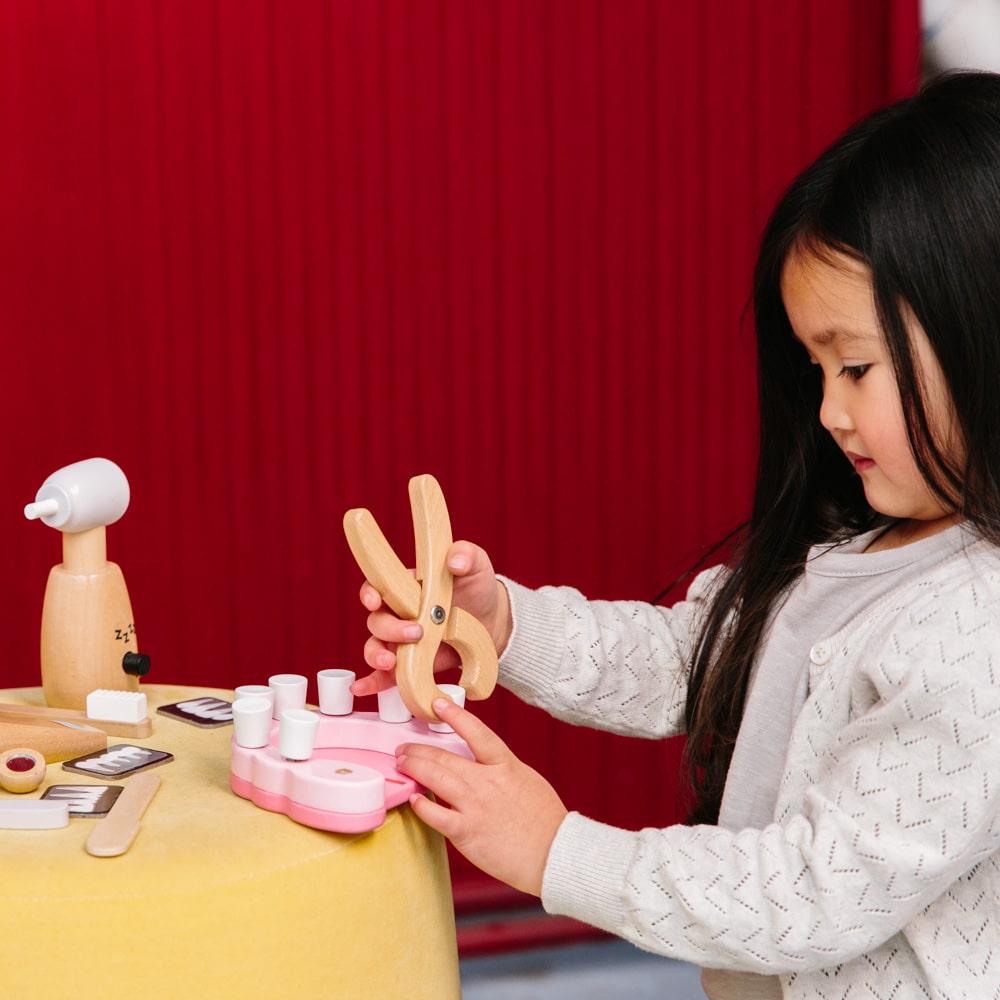 Wooden toy dentist kit with model mouth, removable teeth, dental tools, and carry box for imaginative pretend play