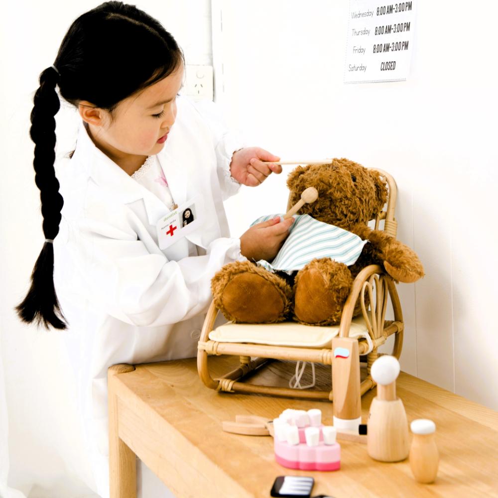 Make Me Iconic wooden toy dentist kit with model mouth, removable teeth, dental tools, and carry box for imaginative pretend play