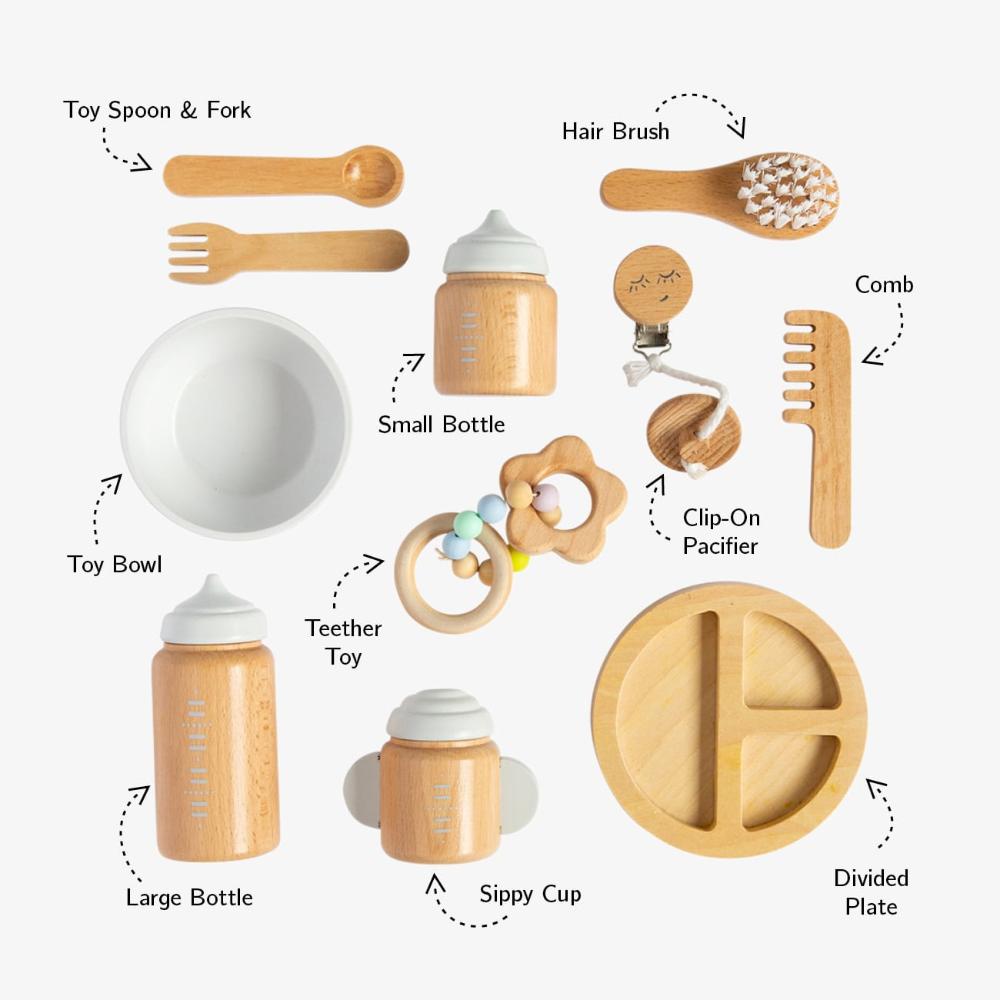 Make Me Iconic 11-piece wooden toy doll accessory kit with bottles, sippy cup, bowl, fork, spoon, brush with real bristles, comb, teether, and clip-on pacifier, perfect for pretend play.