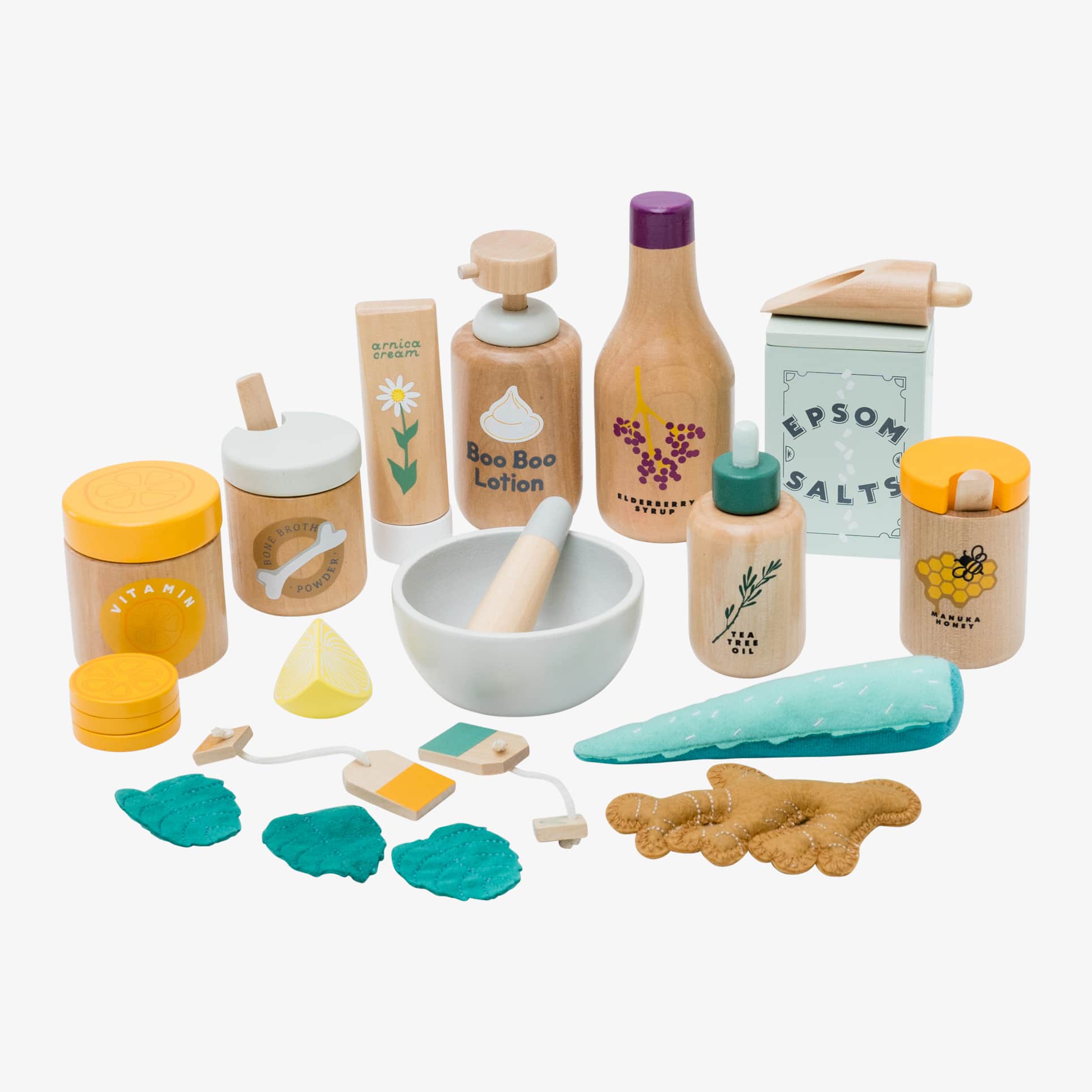 Wooden toy Natural Healers Kit with pestle and mortar, pretend Epsom salts, Manuka honey, bone broth, Tea Tree oil dropper, Boo Boo lotion, vitamins, arnica cream, herbal tea bags, and felt herbs for imaginative wellness play.
