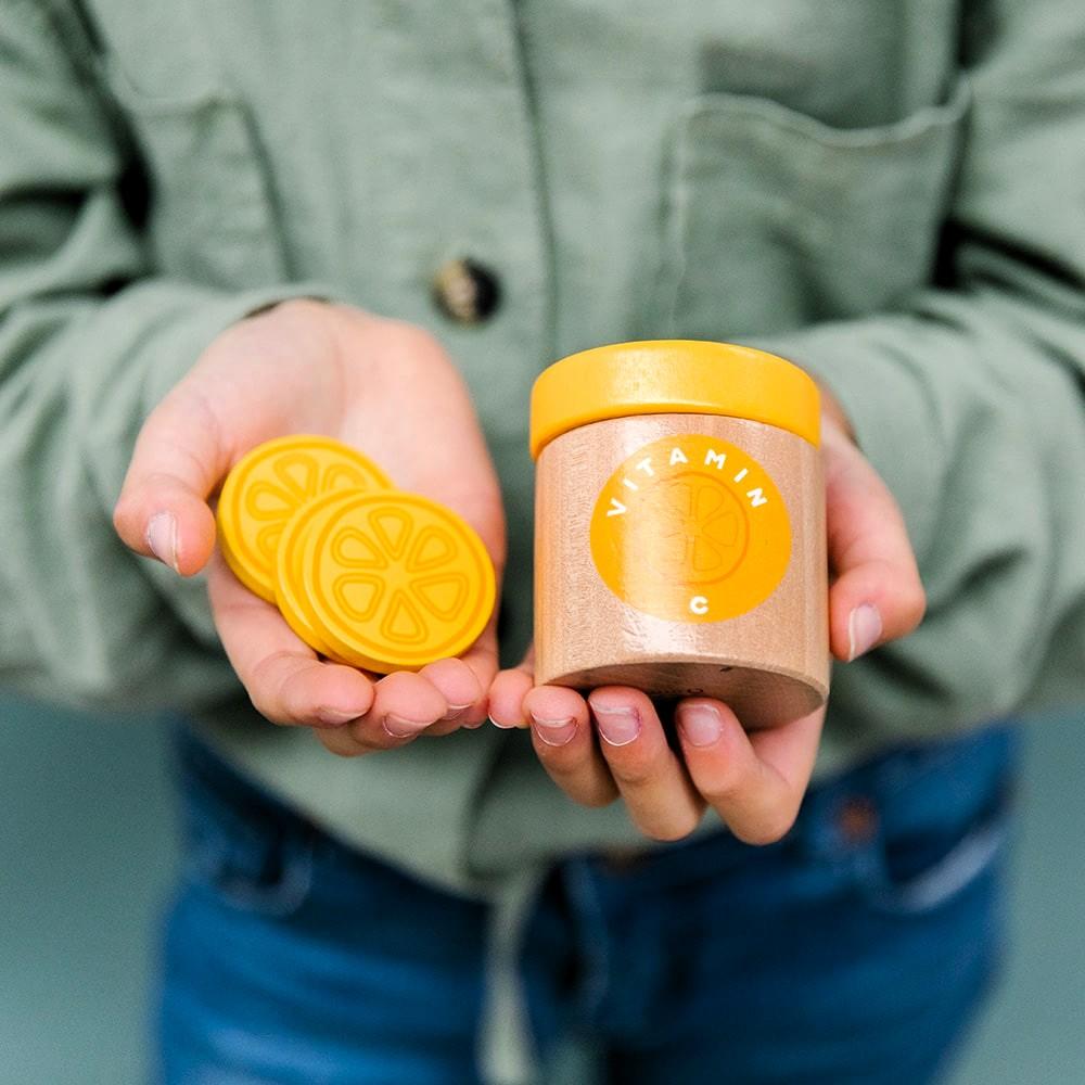 Make Me Iconic wooden toy natural healers kit with pestle and mortar, pretend Epsom salts, Manuka honey, bone broth, Tea Tree oil dropper, Boo Boo lotion, vitamins, arnica cream, herbal tea bags, and felt herbs for imaginative wellness play.