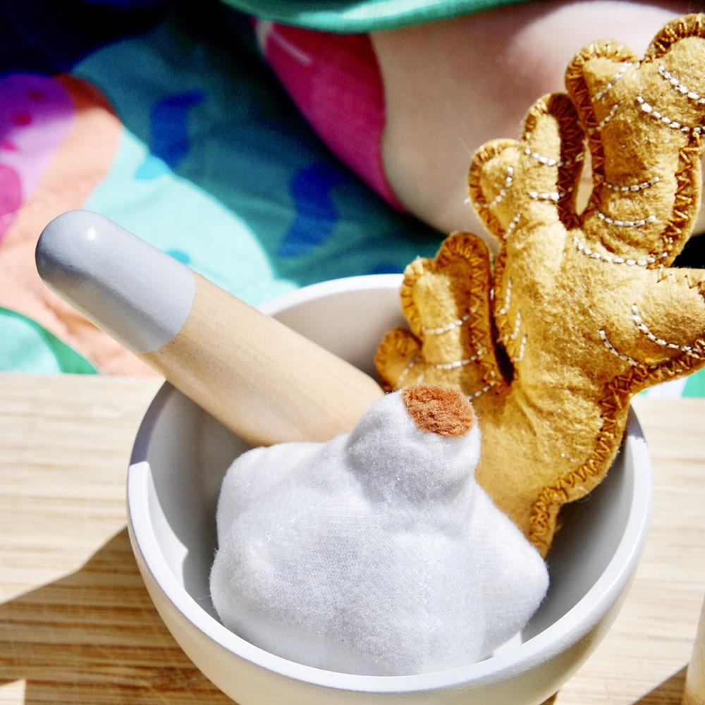 Make Me Iconic wooden toy natural healers kit with pestle and mortar, pretend Epsom salts, Manuka honey, bone broth, Tea Tree oil dropper, Boo Boo lotion, vitamins, arnica cream, herbal tea bags, and felt herbs for imaginative wellness play.