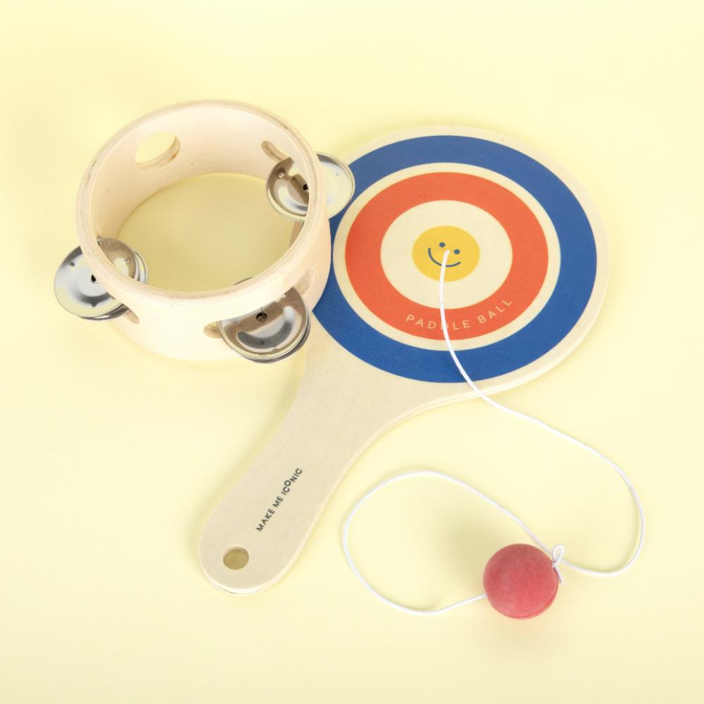 Make Me Iconic wooden paddle ball toy with elastic rubber ball, designed for solo play and developing hand-eye coordination. A classic retro toy perfect for travel, parties, or active play at home.