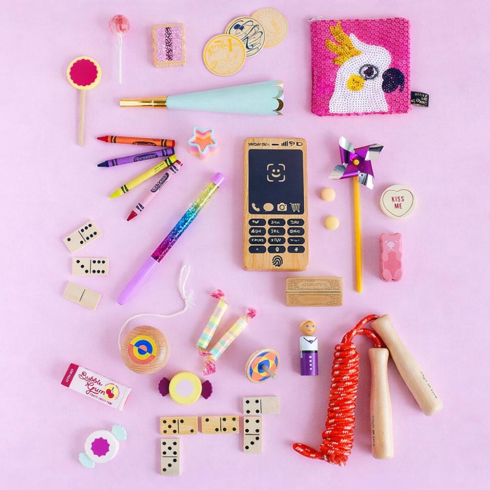 Make Me Iconic Wooden Toy Phone from the Loose Change Range, featuring a realistic design for pretend selfies, texting, and calls. Encourages imaginative, screen-free play for kids who love to copy the grown-ups.