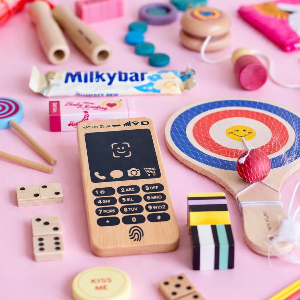 Make Me Iconic Wooden Toy Phone from the Loose Change Range, featuring a realistic design for pretend selfies, texting, and calls. Encourages imaginative, screen-free play for kids who love to copy the grown-ups.