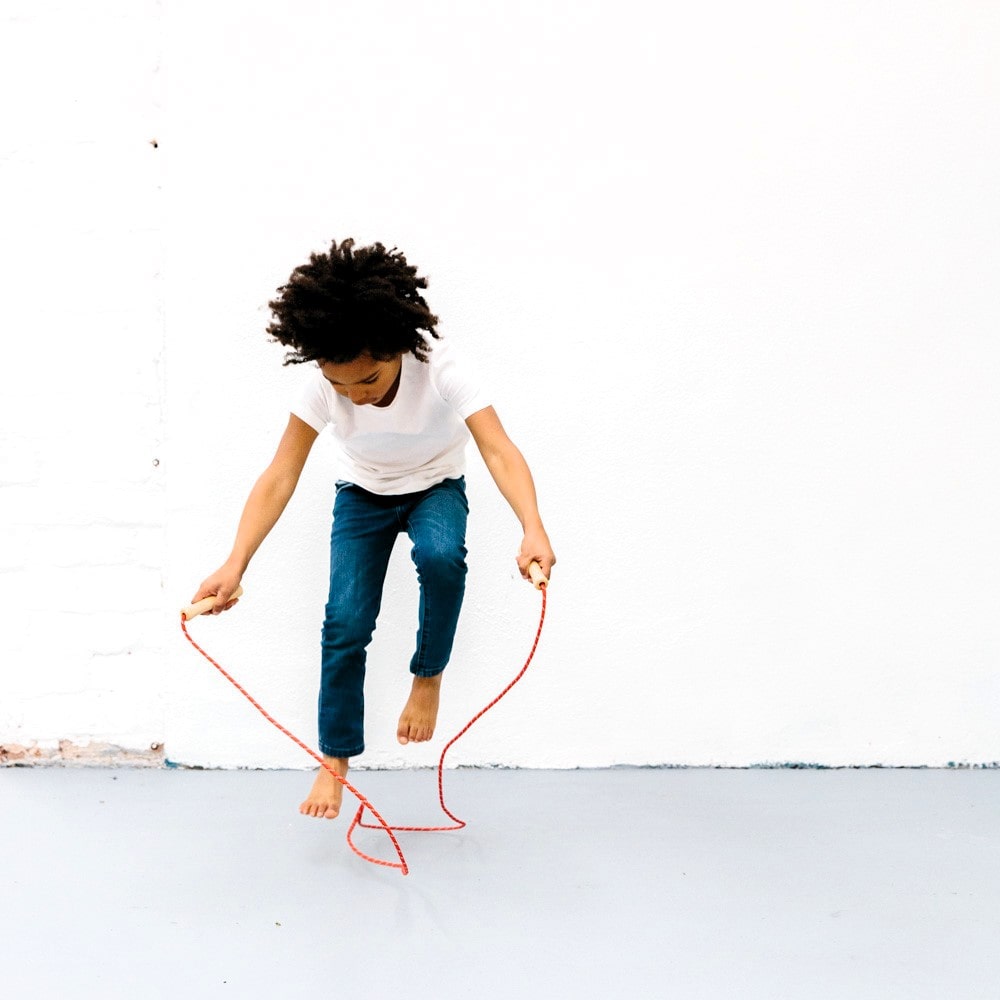 Wooden skipping rope with smooth natural handles and neutral-coloured rope, designed for active play, coordination, and classic childhood fun.