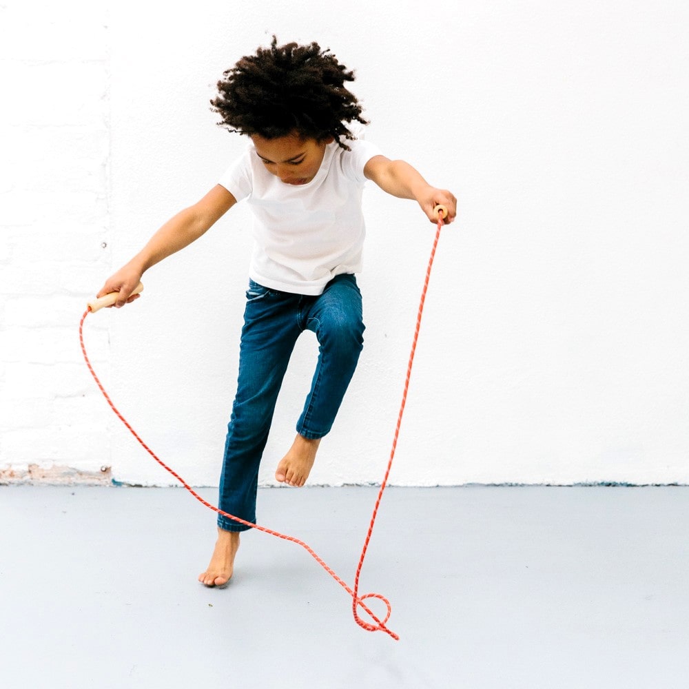 Wooden skipping rope with smooth natural handles and neutral-coloured rope, designed for active play, coordination, and classic childhood fun.