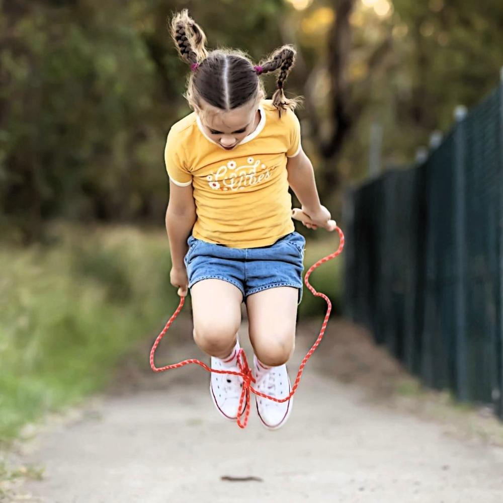Make Me Iconic wooden skipping rope with smooth natural handles and red-coloured rope, designed for active play, coordination, and classic childhood fun.