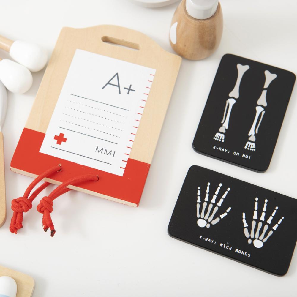 Make Me Iconic Wooden Surgeon Kit featuring toy surgical tools, mini X-rays, and first aid accessories. Inspires imaginative medical play, empathy, and storytelling fun.