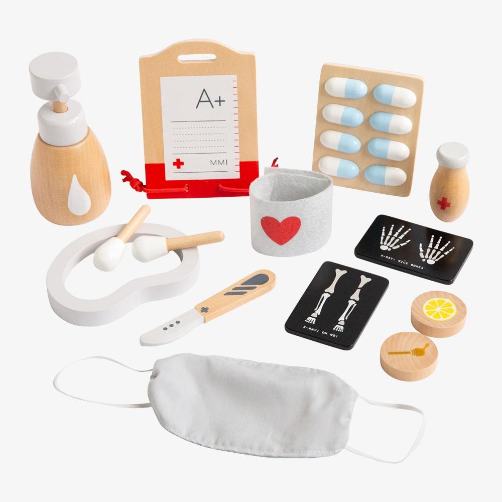 Make Me Iconic Ultimate Role Play Set for kids featuring a wooden Tea Set Extension, Doll Accessory Kit, Beauty Kit and Surgeon Kit, designed for imaginative pretend play, role play, creative learning and screen-free play for toddlers and children.