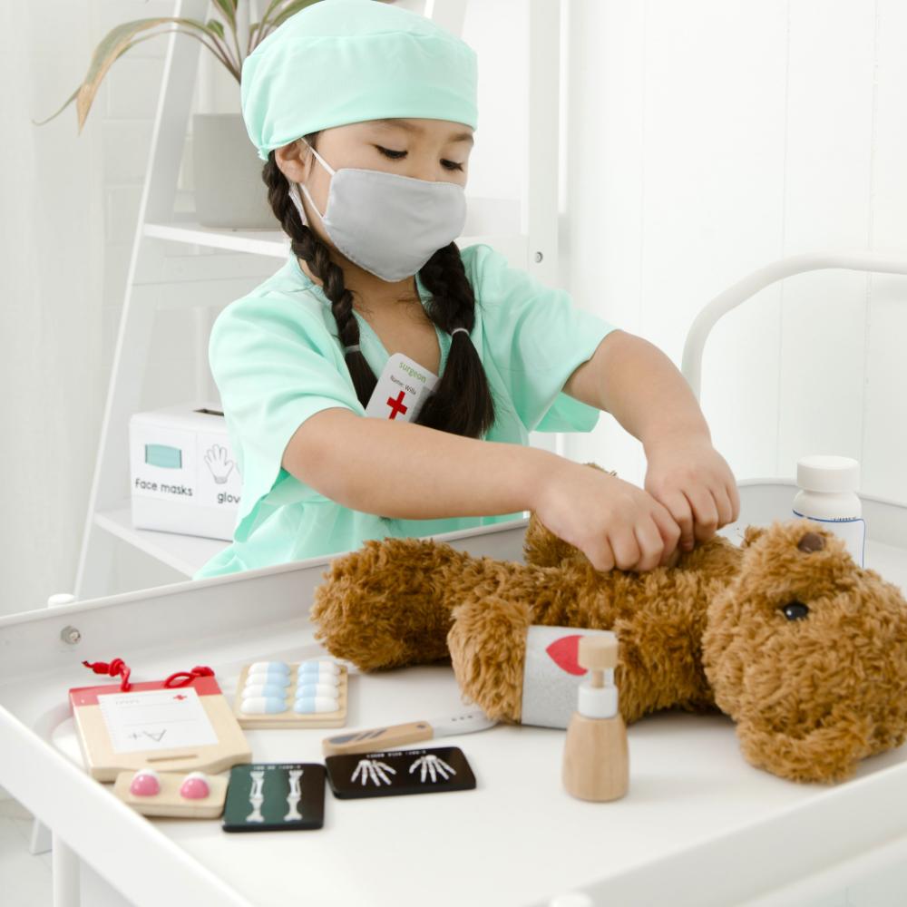 Make Me Iconic Ultimate Role Play Set for kids featuring a wooden Tea Set Extension, Doll Accessory Kit, Beauty Kit and Surgeon Kit, designed for imaginative pretend play, role play, creative learning and screen-free play for toddlers and children.