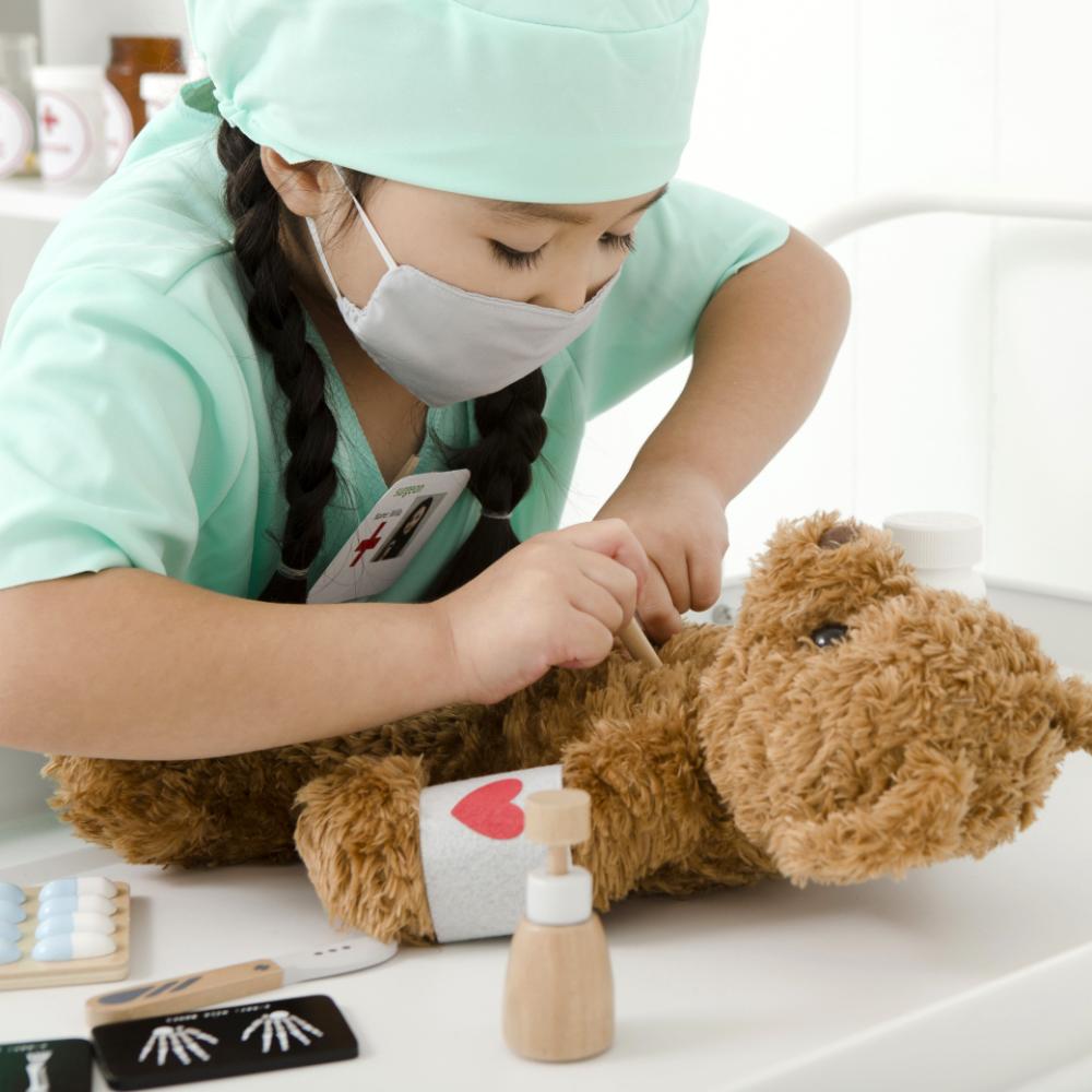 Make Me Iconic Wooden Surgeon Kit featuring toy surgical tools, mini X-rays, and first aid accessories. Inspires imaginative medical play, empathy, and storytelling fun.