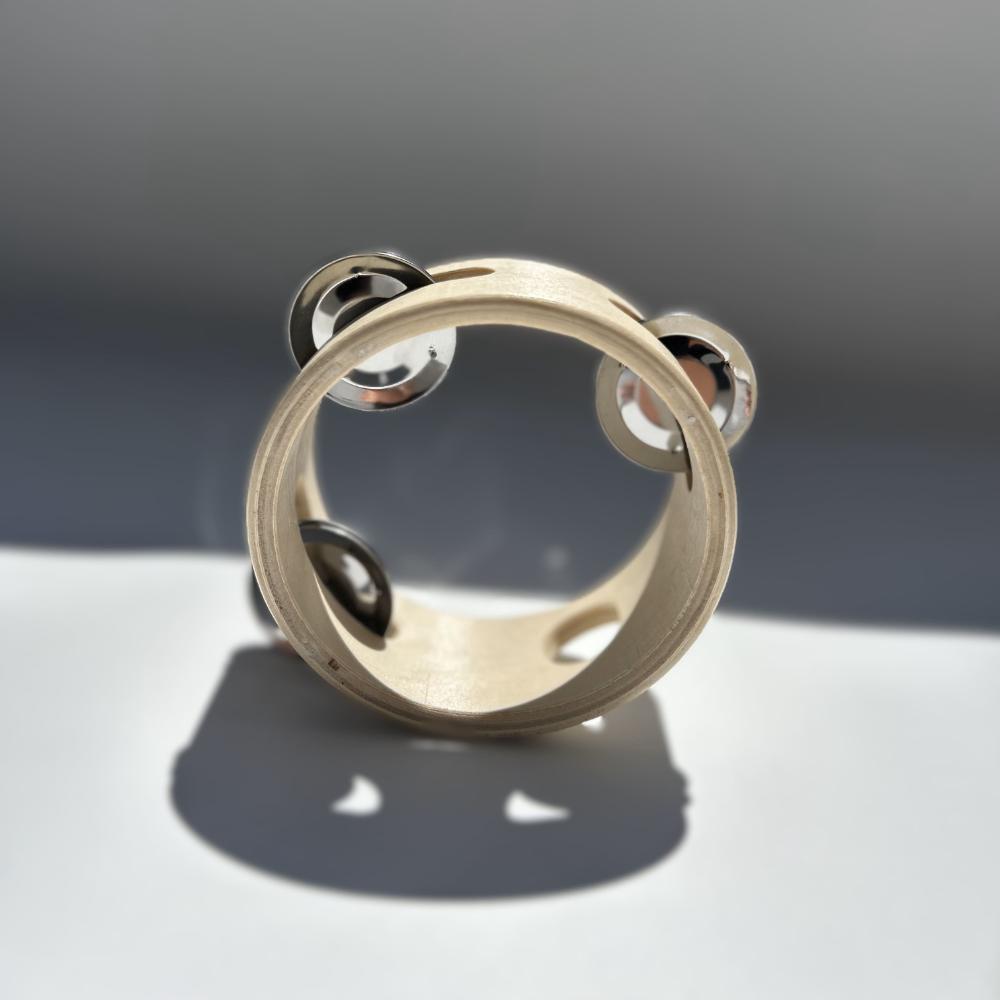 Make Me Iconic 1-piece wooden toy tambourine with a classic round design, perfect for musical pretend play. Encourages young kids to explore rhythm, coordination, and creative expression through music.