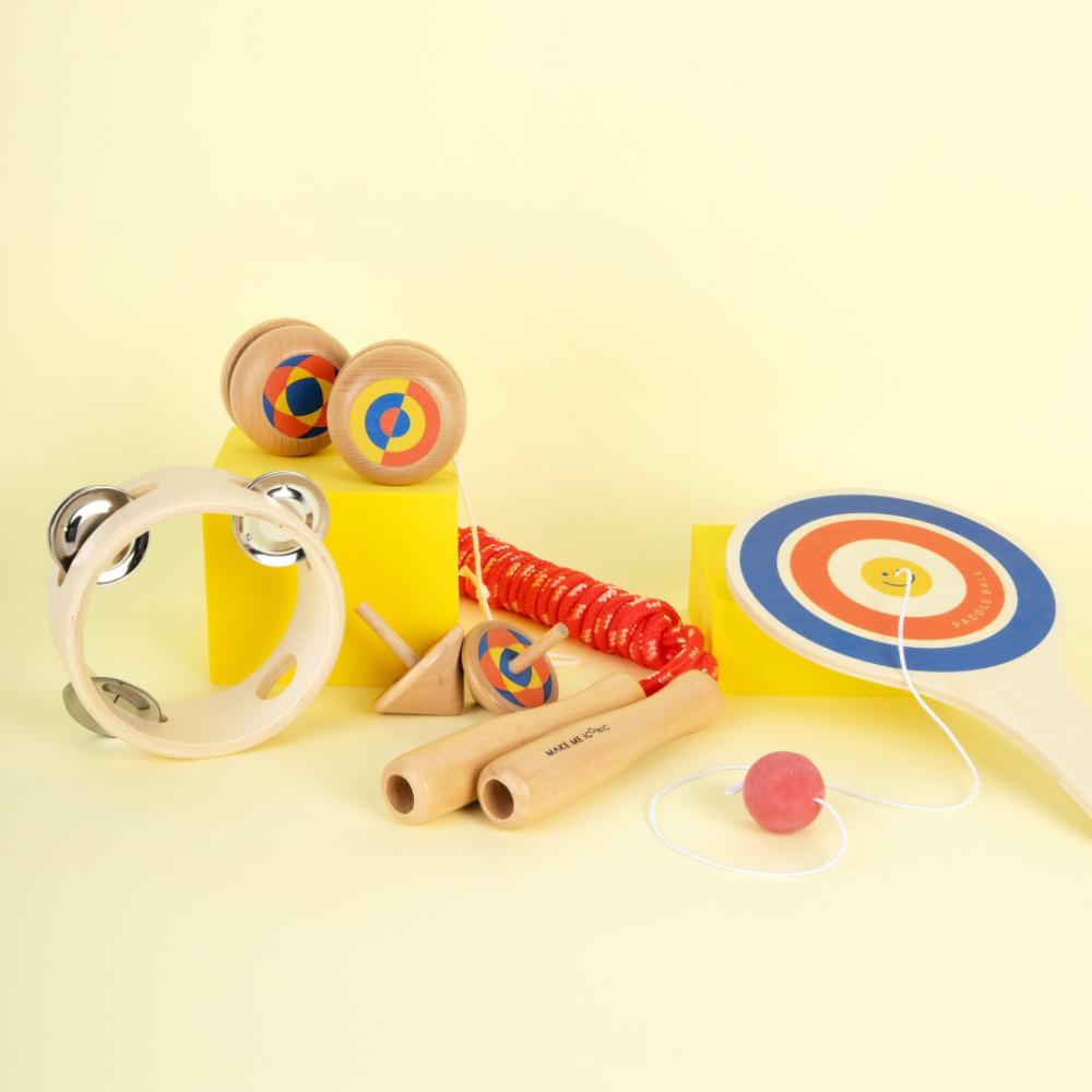 Make Me Iconic 1-piece wooden toy tambourine with a classic round design, perfect for musical pretend play. Encourages young kids to explore rhythm, coordination, and creative expression through music.