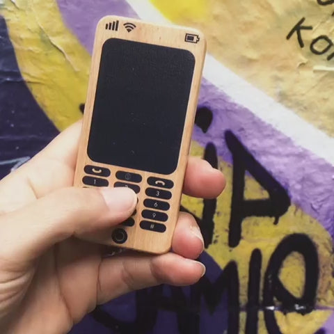 Make Me Iconic Wooden Toy Phone from the Loose Change Range, featuring a realistic design for pretend selfies, texting, and calls. Encourages imaginative, screen-free play for kids who love to copy the grown-ups.
