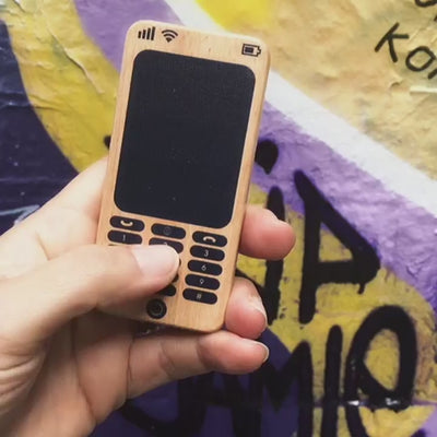 Make Me Iconic Wooden Toy Phone from the Loose Change Range, featuring a realistic design for pretend selfies, texting, and calls. Encourages imaginative, screen-free play for kids who love to copy the grown-ups.